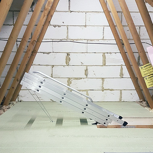 Folded aluminium loft ladder above hatch